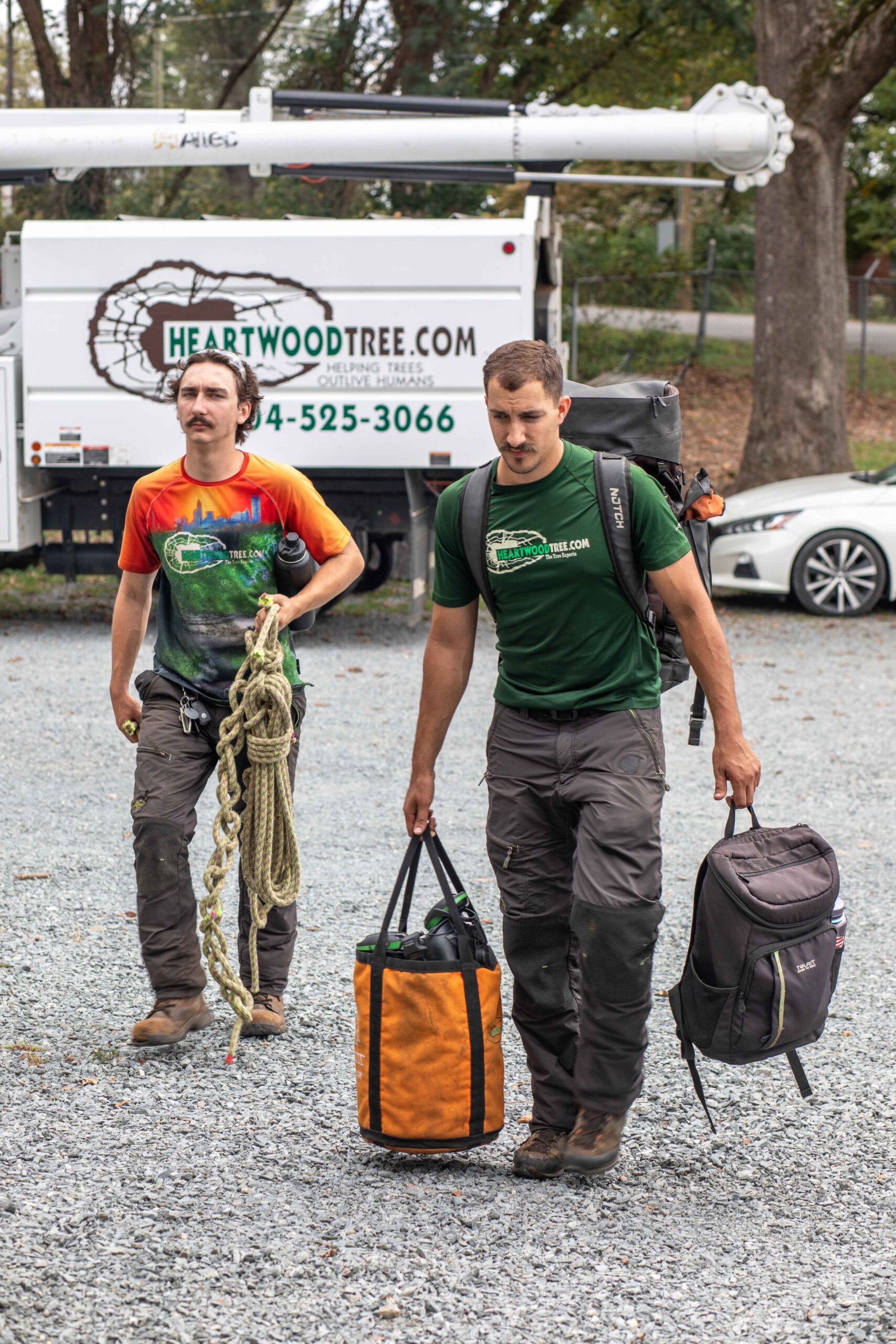 Two arborists arriving at a tree care work site